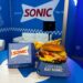 fast food items on a table with a blue background