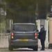 A police officer talks to a driver inside a car outside Royal Lodge on the Windsor Estate.
