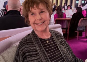 Nancy Guthrie smiling while seated at a restaurant.