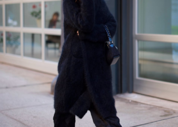 person walking on a sidewalk in urban setting
