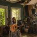 Audra Kubat poses inside A Detroit House of Music, where she lives, hosts concerts and songwriting workshops, and tends to a community garden.