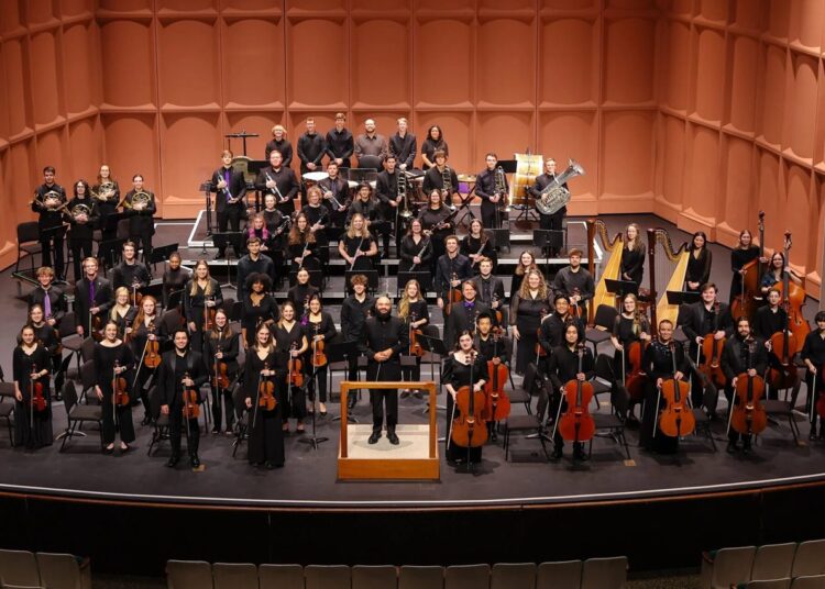 Members of an orchestra on a stage. Furman Symphony Orchestra.