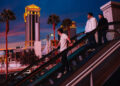 Pedestrians ride an escalator across from Caesars Palace on the Strip Sunday, Feb. 15, 2026, in ...