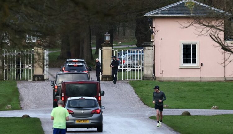 A convoy with police officers travels into the Royal Lodge on Saturday. Pic: Reuters