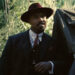 Michael B. Jordan leaning against a truck in Sinners. .