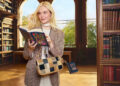 Elle Fanning reads Jane Austen’s “Sense and Sensibility” in a library setting while styling a patchwork Coach bag from the spring campaign.