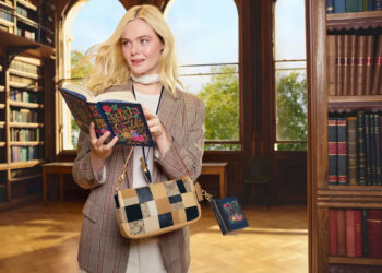 Elle Fanning reads Jane Austen’s “Sense and Sensibility” in a library setting while styling a patchwork Coach bag from the spring campaign.