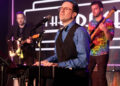 Producer and band leader Kenny Davidsen sings during a birthday party benefit for Las Vegas Rev ...