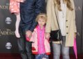 Eric Dane carries one young daughter and holds the other daughter's hand along with wife Rebecca Gayheart