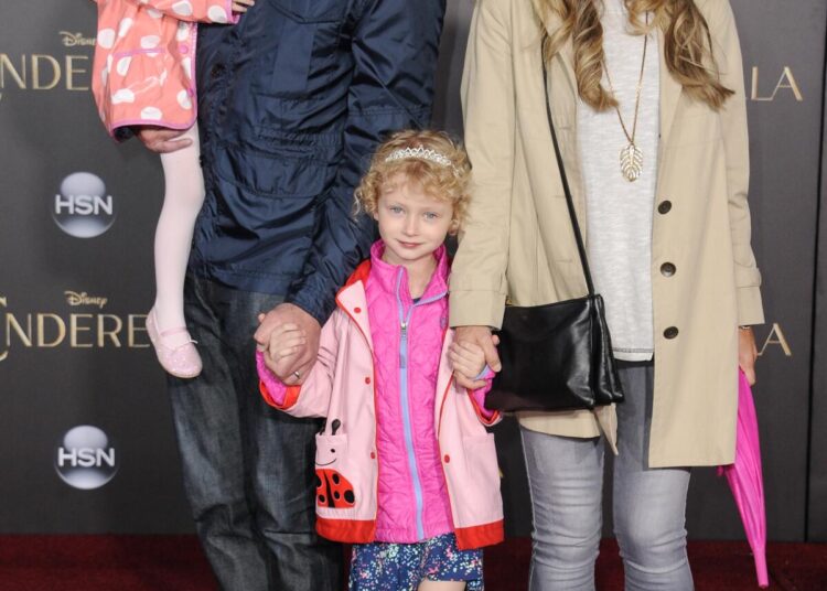 Eric Dane carries one young daughter and holds the other daughter's hand along with wife Rebecca Gayheart