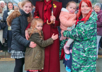 Catherine, Princess of Wales, takes a moment to greet young well-wishers during her visit to Wales.