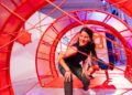woman navigating obstacles in brightly colored room