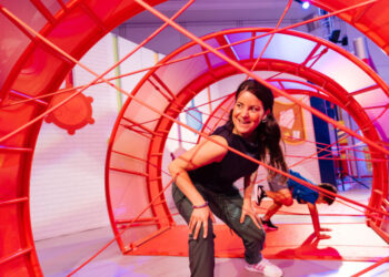 woman navigating obstacles in brightly colored room