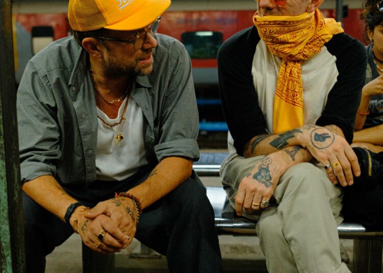 Damon Albarn, left, and Jamie Hewlett, right, of Gorillaz, sit on a bench in Varanasi, India.