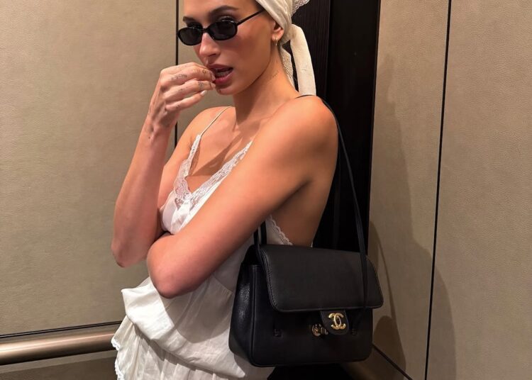 Hailey Bieber styled a lace lingerie-inspired skirt set from Magda Butrym with the triangle hair scarf trend and a new Chanel bag