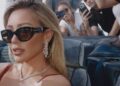 Image may contain: Hilary Duff, Accessories, Sunglasses, Person, Photobombing, Electronics, Mobile Phone, Phone, and Glasses