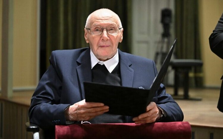 Hungarian composer Gyorgy Kurtag looks on as he holds his 'Doctor Honoris Causa' he received from the University 'Liszt Ferenc Academy of Music' in Budapest in February 2026