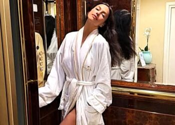 Irina Shayk Poses in White Hotel Robe Amid Sanremo 2026 Appearance