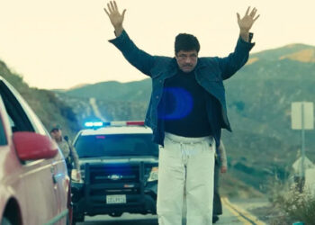 Sensei Sergio dance-walking in front of the cops in One Battle After Another