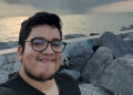 young male on rocky beach