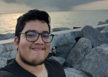 young male on rocky beach