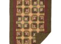 Olive green and maroon patterned quilt