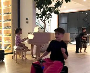 Reign Disick appears to ride an electric suitcase as Chicago West plays piano Kim Kardashian/Instagram