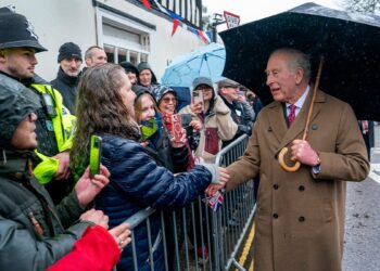 king charles shakes hands during city visit