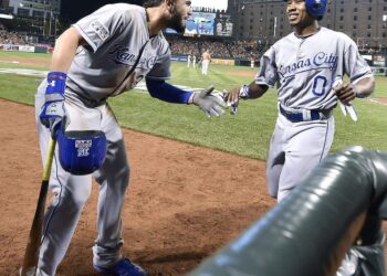 Kansas City Royals first baseman Eric Hosmer, left, congratulated Terrance Gore after Gore scored on a double by Alcides Escobar for the go-ahead run in the ninth inning of an ALCS game against the Orioles at Camden Yards in Baltimore, Maryland on Oct. 11, 2014.