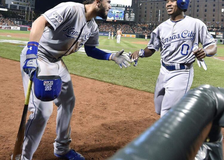 Kansas City Royals first baseman Eric Hosmer, left, congratulated Terrance Gore after Gore scored on a double by Alcides Escobar for the go-ahead run in the ninth inning of an ALCS game against the Orioles at Camden Yards in Baltimore, Maryland on Oct. 11, 2014.