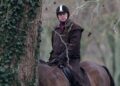 A man riding a horse, looking on