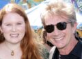 Katherine and Martin Short standing and smiling together in 2021