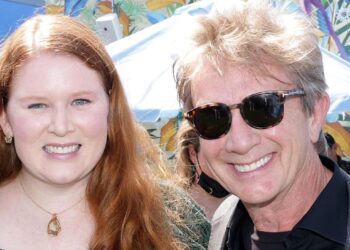 Katherine and Martin Short standing and smiling together in 2021