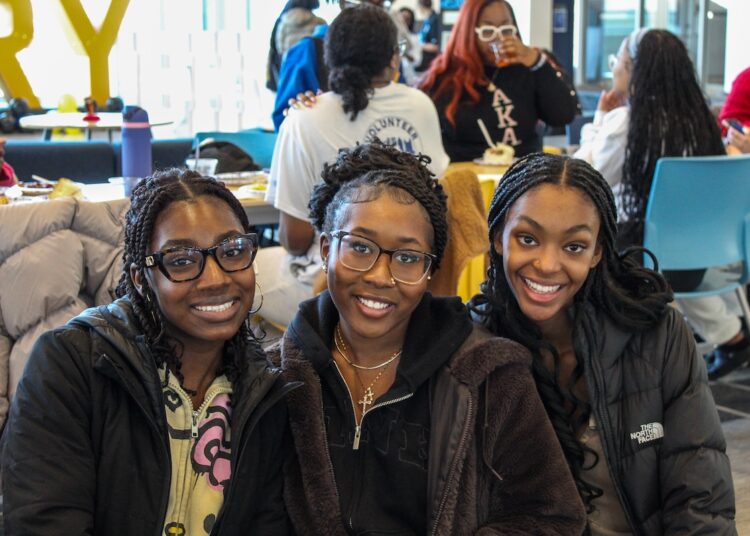 three students celebrate Black History Month