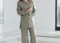 molly gordon in a tailored suit standing indoors