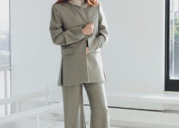 molly gordon in a tailored suit standing indoors