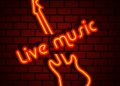 A neon sign of live music on a wall