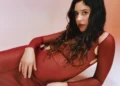 Eliza in a red dress, featured in our best new music list.