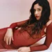Eliza in a red dress, featured in our best new music list.