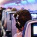 Playing loud music on a flight could spell trouble