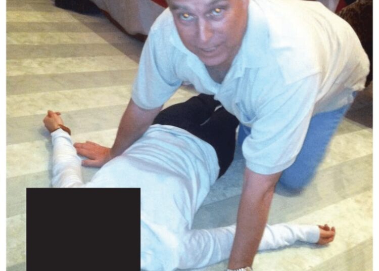 Andrew Mountbatten-Windsor leans over an unidentified woman in an undated photo released by the Department of Justice.