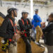 BGE President and CEO Tamla Olivier, right, talks with trainees Zaire Ferges, left, and Kaion Parks as Civic Works Solar Fields Manager Philip Lawrence looks on following Olivier’s announcement of a $250,000 grant for Civic Works solar installations, Dec. 15, 2025. (Photo courtesy of BGE)