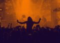 a woman on someone's shoulders in a crowd