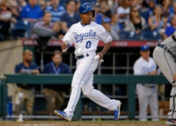 Terrance Gore in a white Kansas City Royals uniform runs on the field.