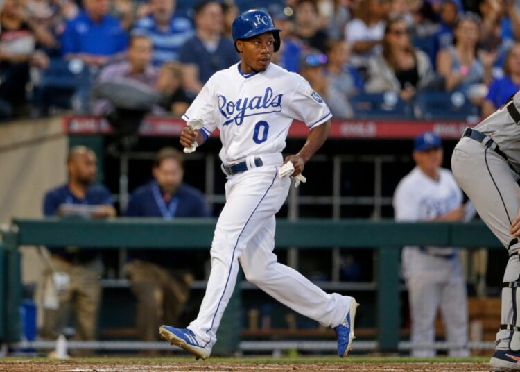 Terrance Gore in a white Kansas City Royals uniform runs on the field.