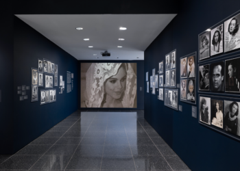 gallery interior displaying framed photographs on dark walls