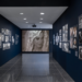 gallery interior displaying framed photographs on dark walls
