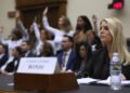 Attorney General Pam Bondi testifies before a House Judiciary Committee as Jeffrey Epstein survivors behind her.