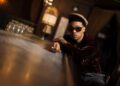 Anderson .Paak stands in his restaurant lounge