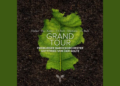A green leaf on soil with text: Grand Tour, Freiburger Barockorchester, Gottfried von der Goltz, Fischer, Pez, Kusser, J.S. Bach, Telemann, J.L. Bach.